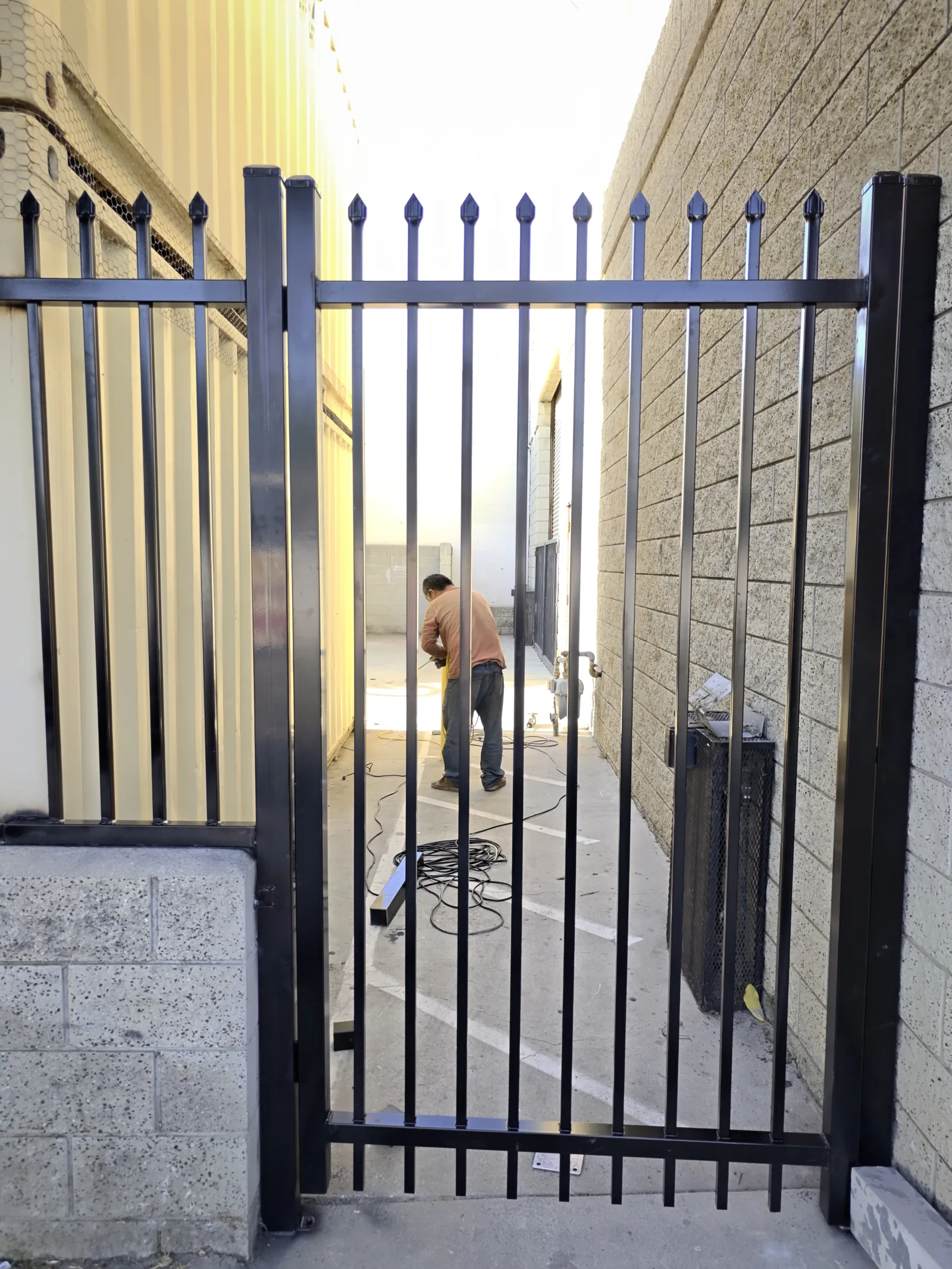 6-foot steel pedestrian swing gate with spear-top pickets and cane bolt in Los Angeles by Apexguard Fence