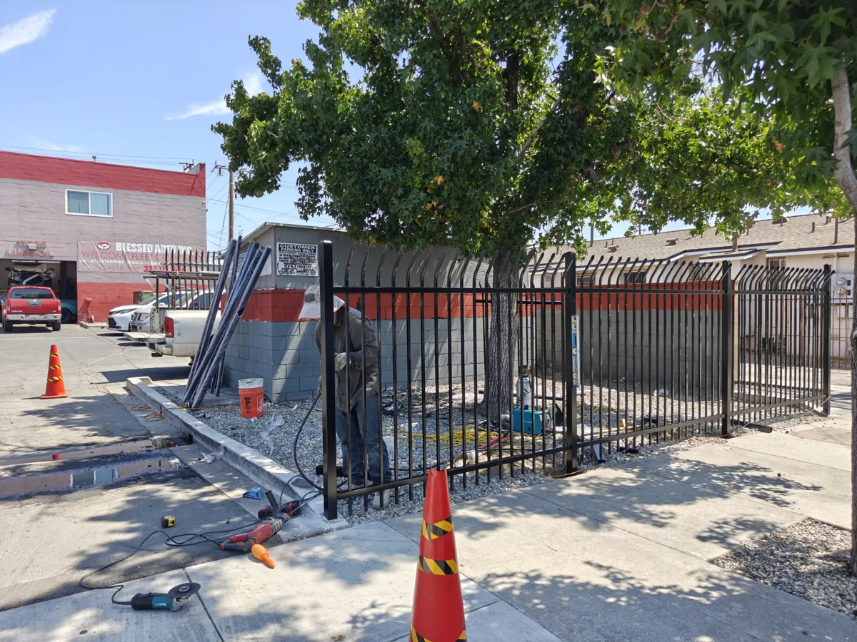 Apexguard Fence crew installing a commercial steel security fence on a Bell Gardens, CA commercial lot
