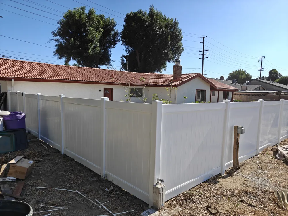 6-foot white vinyl privacy fence in a Chino, CA backyard by Apexguard Fence