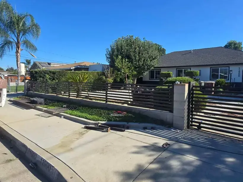 Wrought iron and brick driveway gate by Apexguard Fence