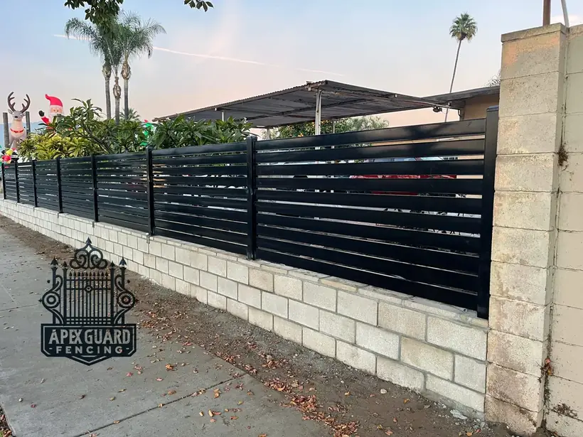 Modern wrought iron slat fence by Apexguard Fence