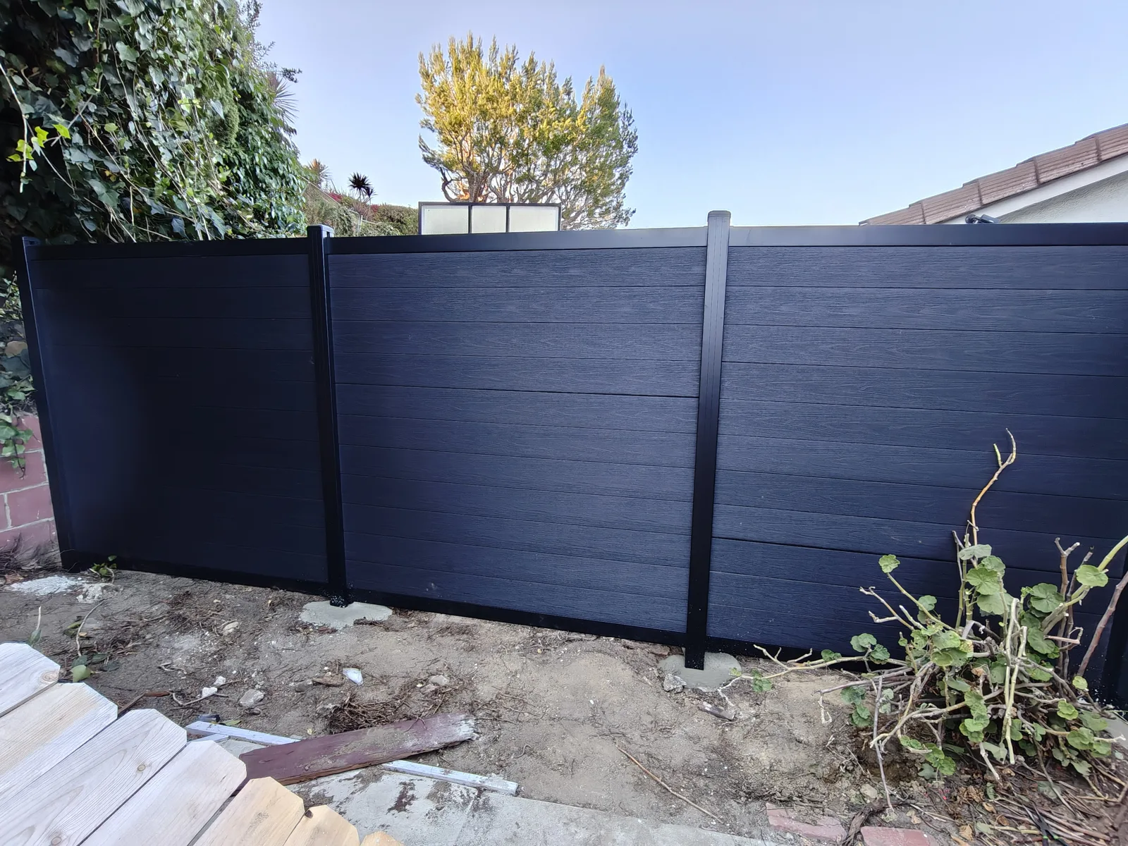 Charcoal WPC composite fence run replacing an old wood fence in Los Angeles by Apexguard Fence