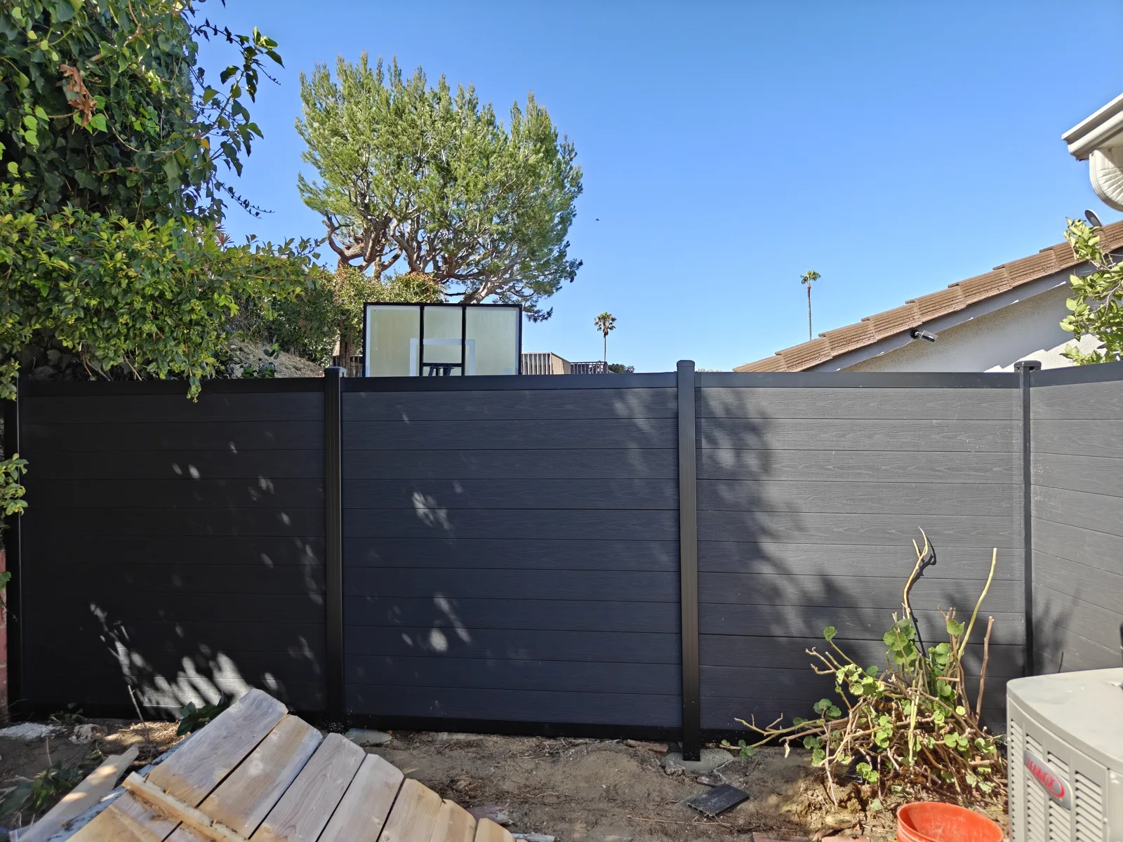 Charcoal composite (WPC) fence in a Los Angeles backyard by Apexguard Fence