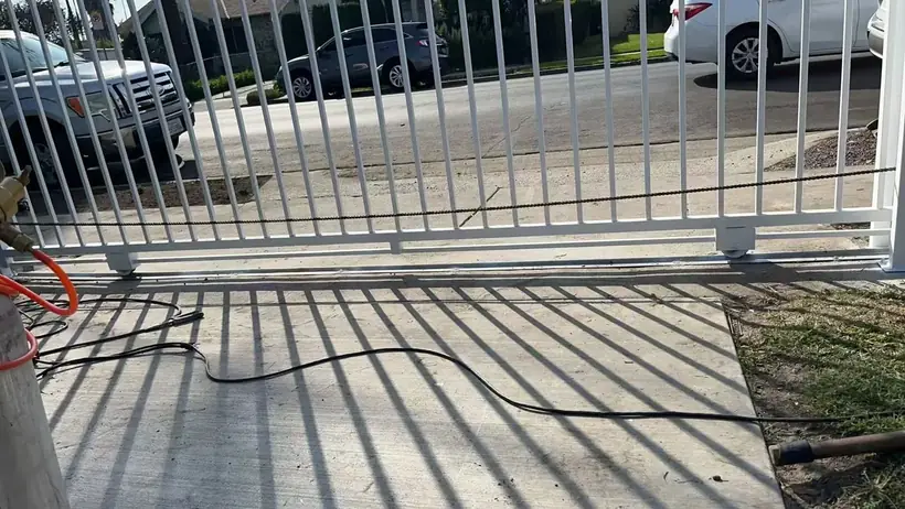 Black iron sliding driveway gate by Apexguard Fence, Southern California