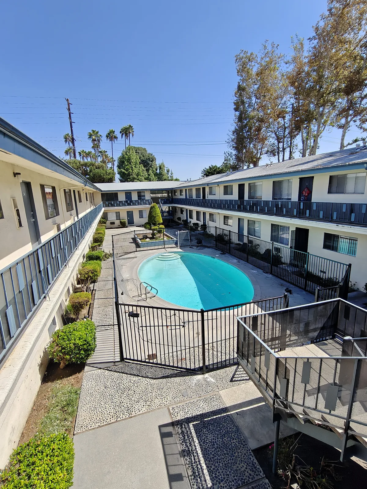 Black iron pool fence enclosing an apartment courtyard pool in West Covina, CA by Apexguard Fence