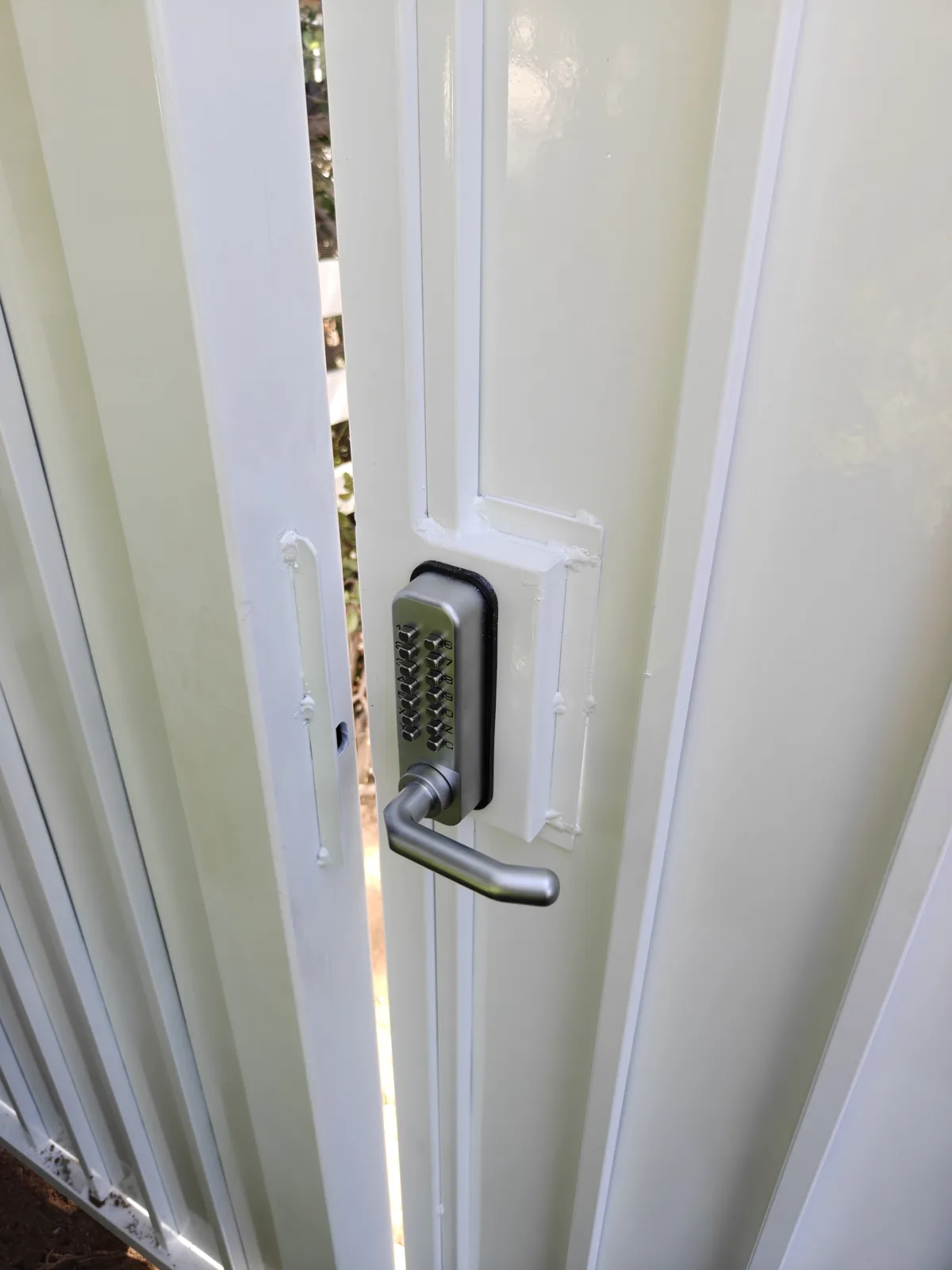 Mechanical keypad lock detail on a steel walk gate in West Covina, CA by Apexguard Fence
