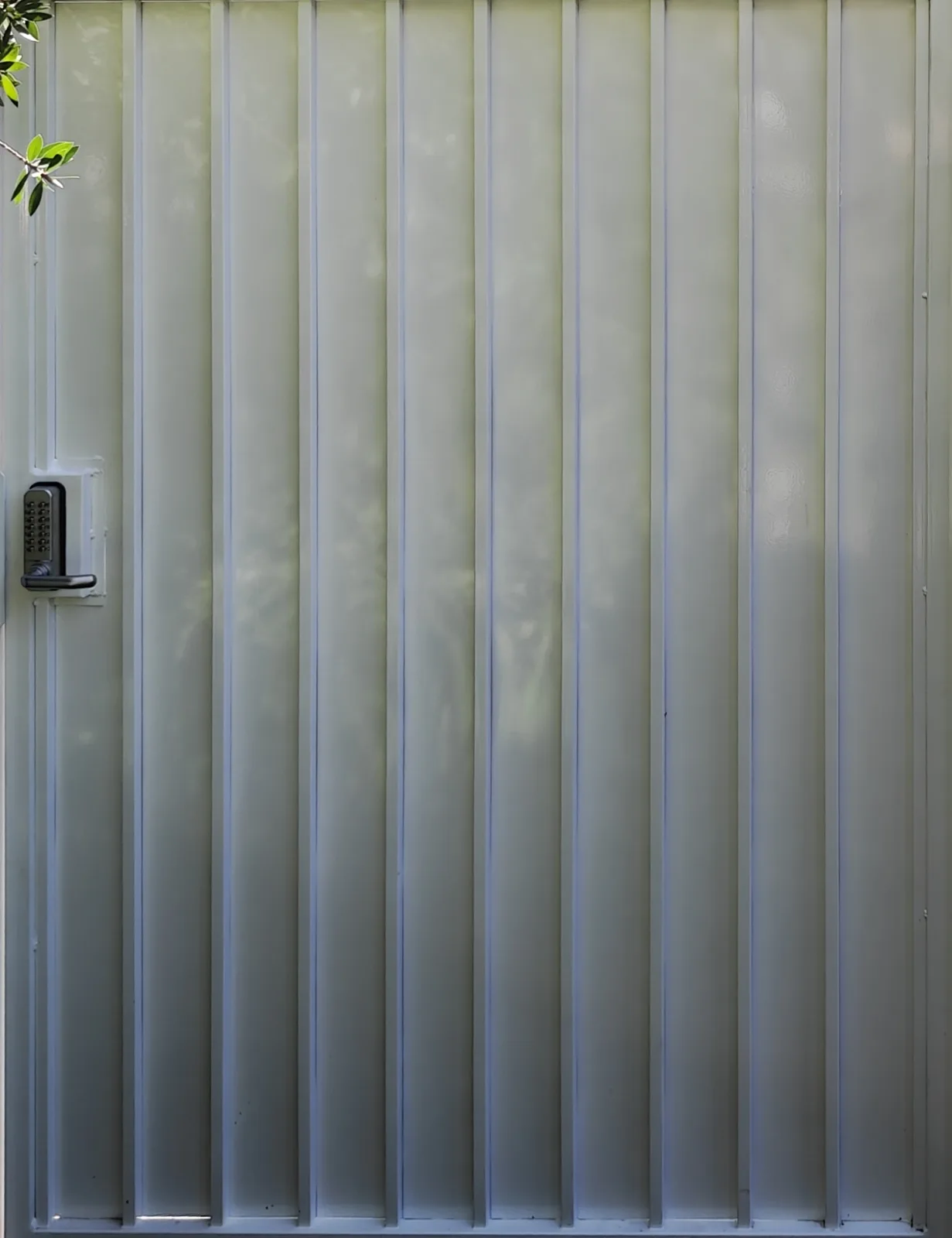 Ribbed steel panel face of a white walk gate with keypad lock in West Covina, CA by Apexguard Fence